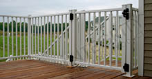 White Aluminum Fence Gate Attached to Backyard Deck